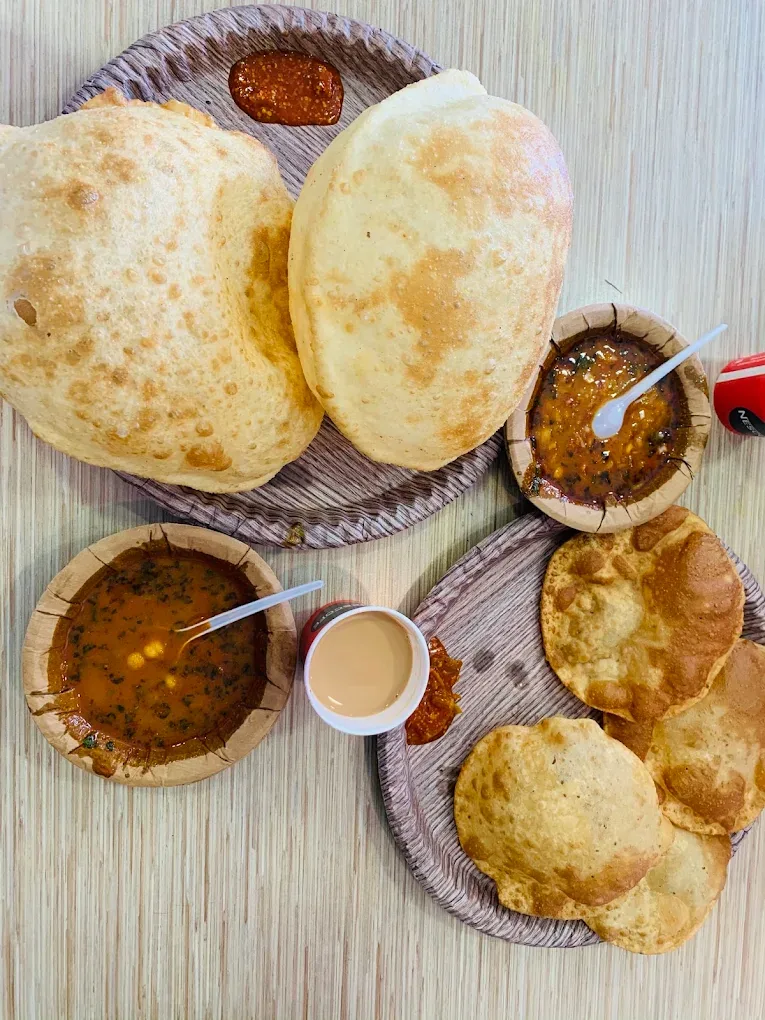 Chola Bhatura — two puffed bhature with chickpea chola